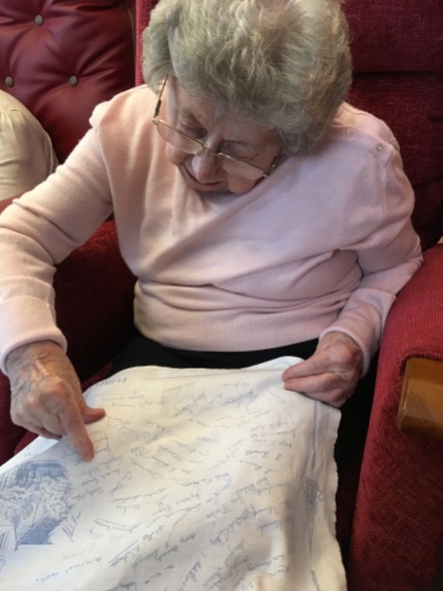 Jean searching the tea towel for her signature and that of her sisters. To read the story of this tea towel, go to Guest Tea Towels 2017 and read Jean’s Guest Tea Towel and why she liked it so much